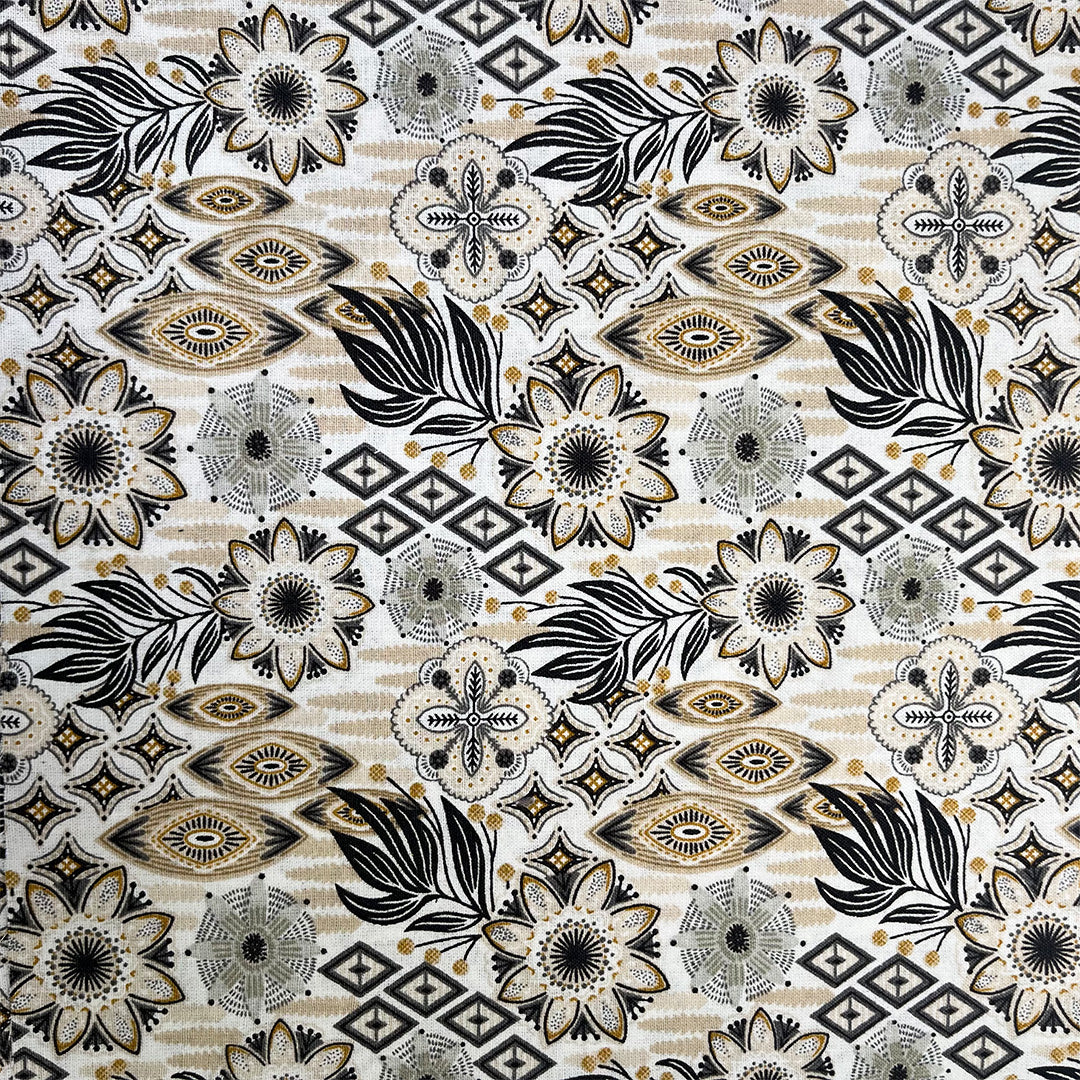 Patterned fabric with black, white, and gold design on a beige background