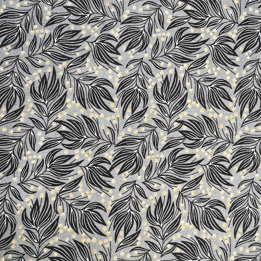 Pattern of black leaves and small yellow flowers on a gray background