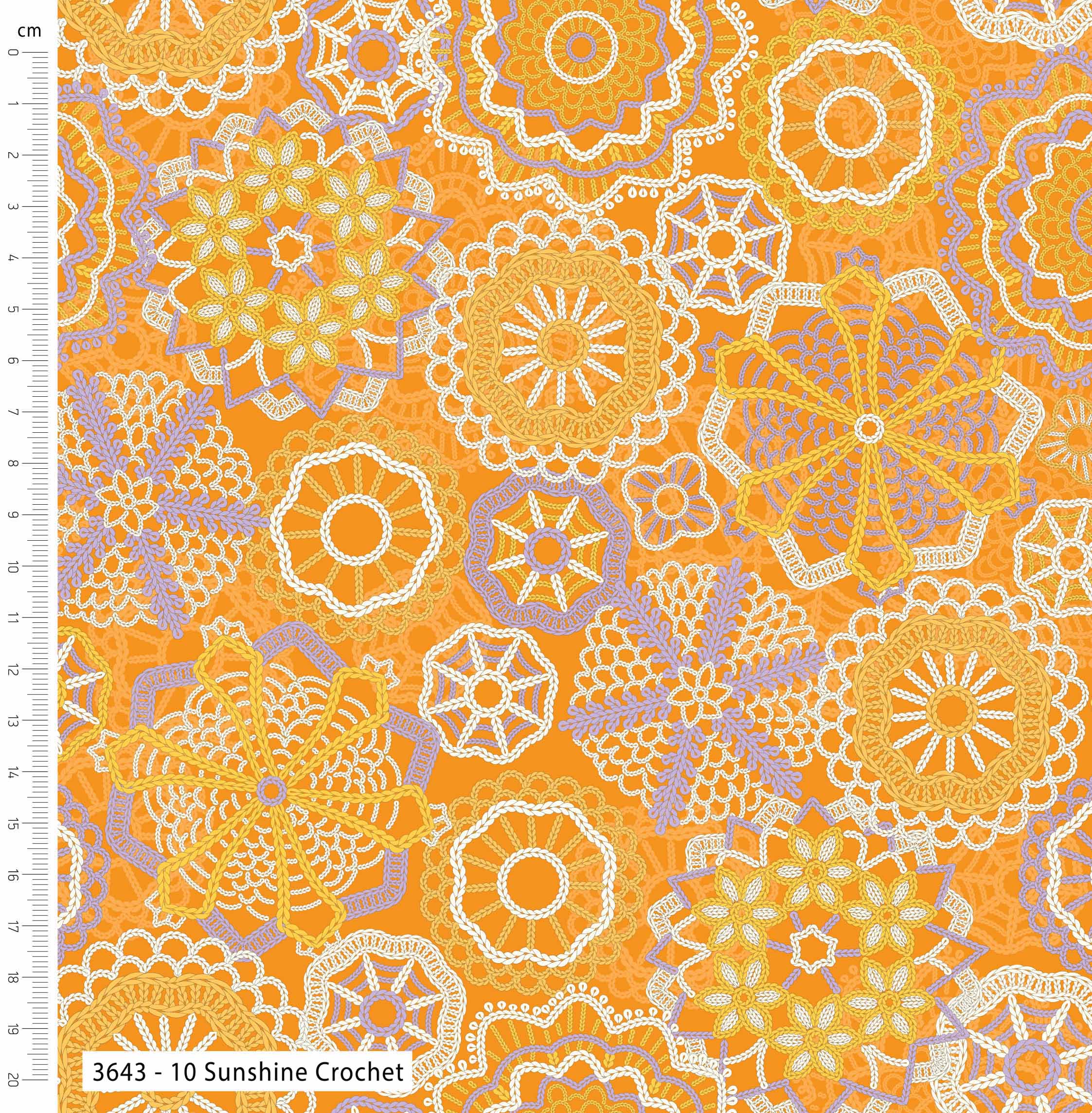 Patterned fabric with floral designs on an orange background, featuring a ruler for scale.