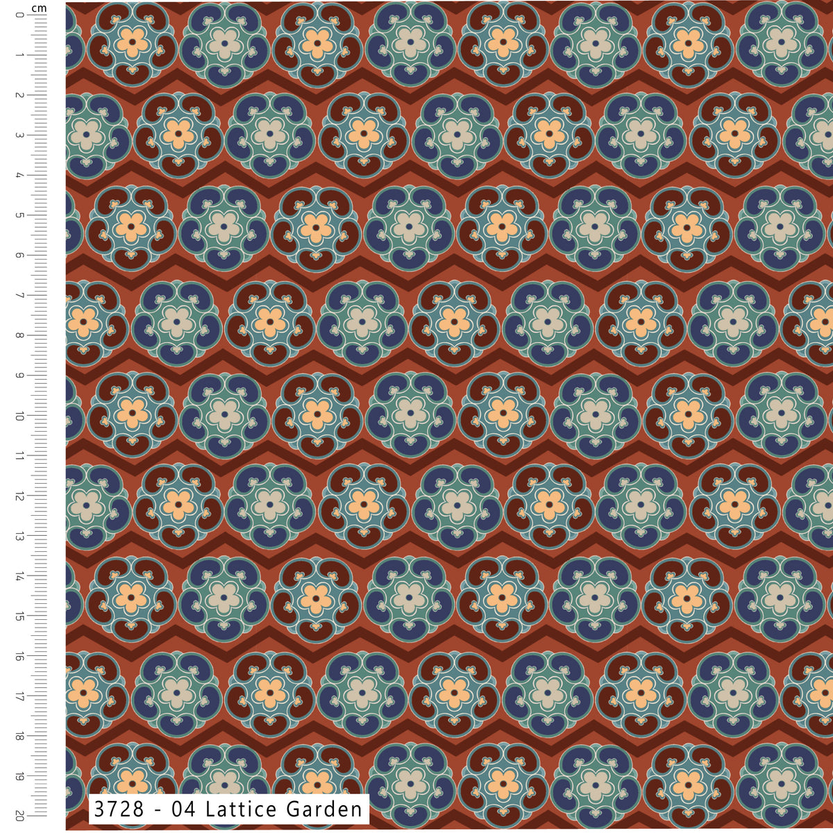 Patterned fabric with lattice design on a brown background, shown with a ruler for scale.