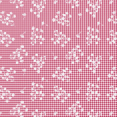 Red and white checkered pattern with small white floral designs on a fabric background