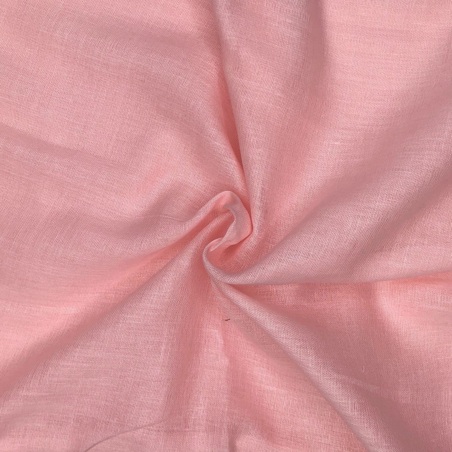 Close-up of pink fabric with a visible thread

