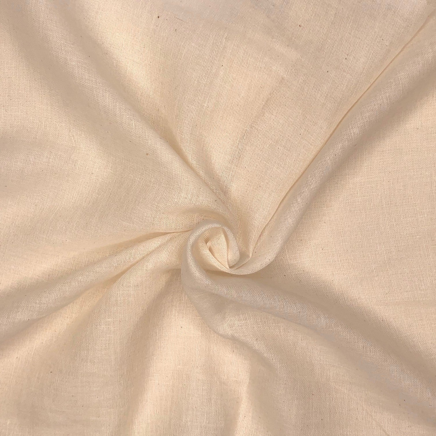 Close-up of beige fabric with a swirl pattern

