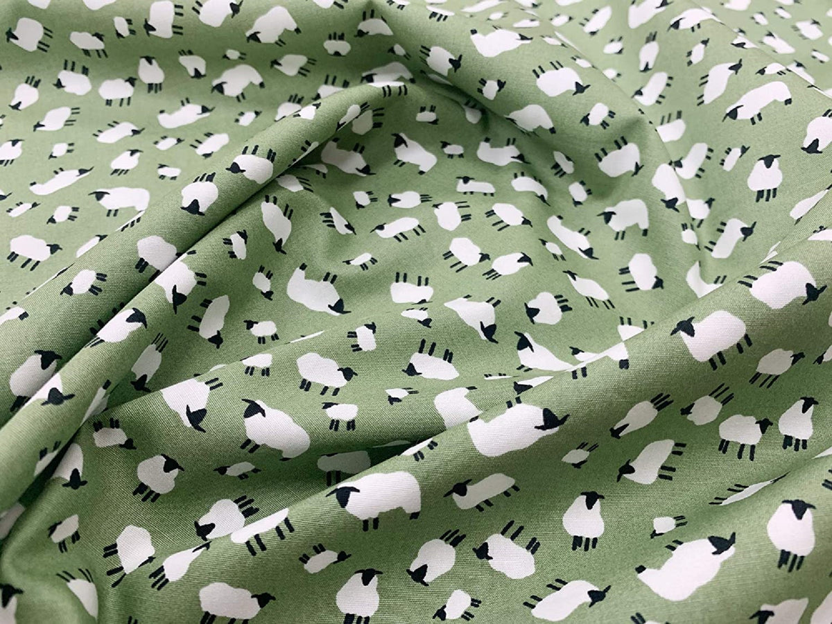 Scattered sheep print cotton poplin fabric by rose and hubble in sage green